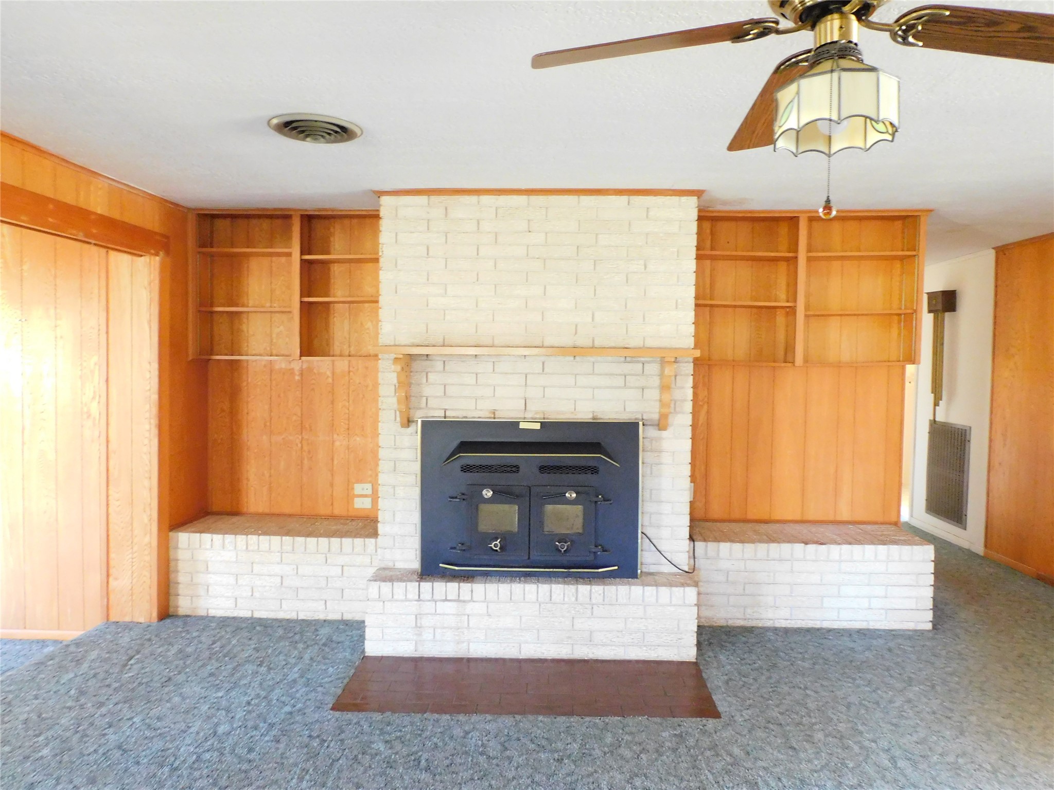 2408 Gun And Rod Road Brenham, TX 77833 - Photo 8 of 16 a living room with a fireplace and a chandelier