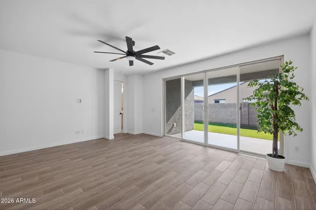 a view of a kitchen with wooden floor and stainless steel appliances