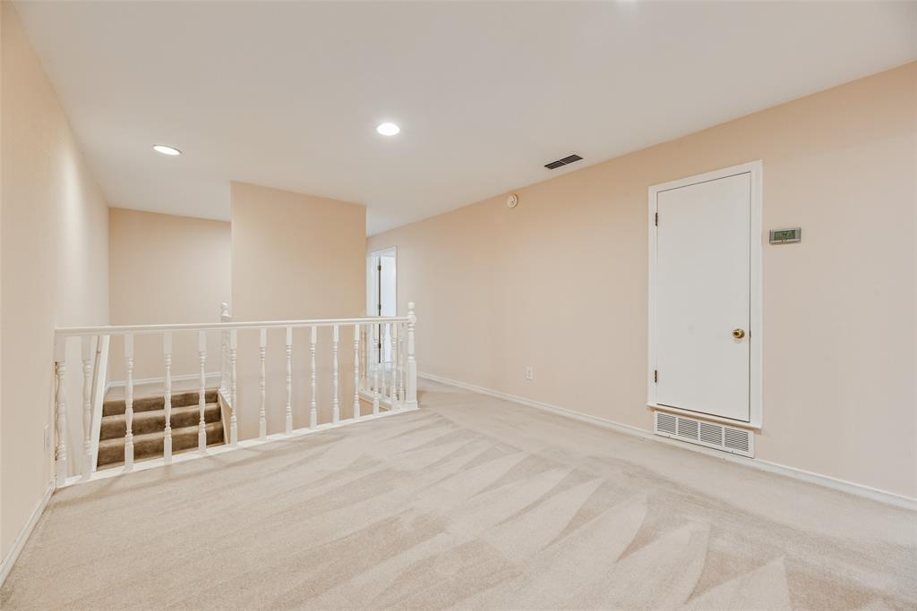 4988 Thunder Road Dallas, TX 75244 - Photo 25 of 32 Carpeted landing featuring a white painted baluster railing, recessed lighting, and a neutral wall color