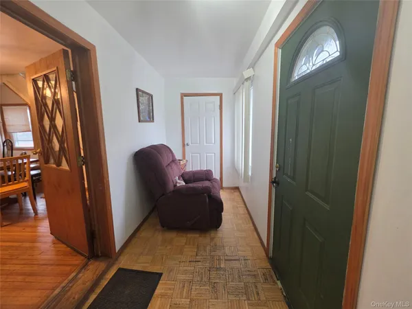 a living room with furniture and a mirror