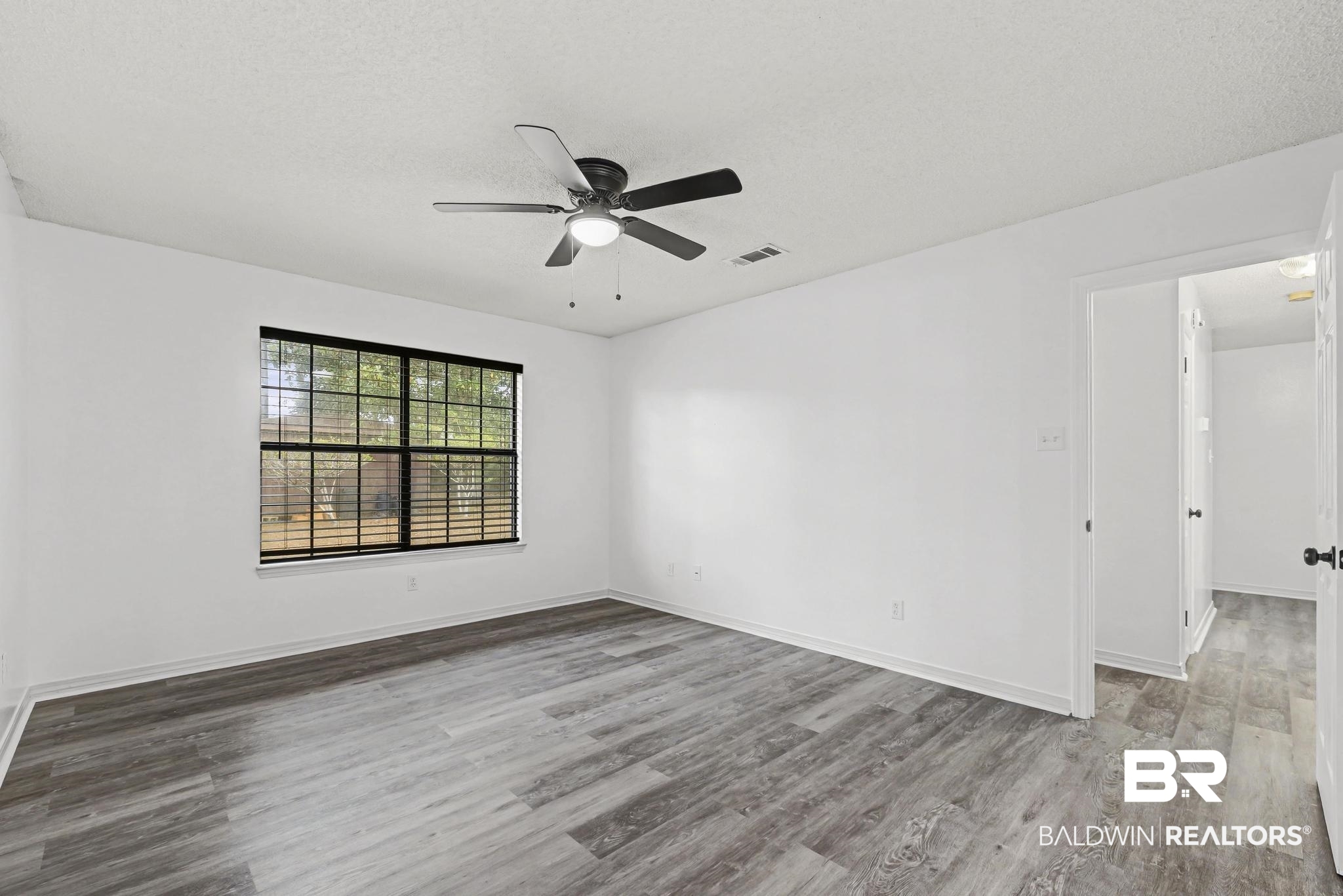 2776 Santa Rosa Circle Lillian, AL 36549 - Photo 18 of 48 Spare room with a ceiling fan, light wood-style floors, and a textured ceiling