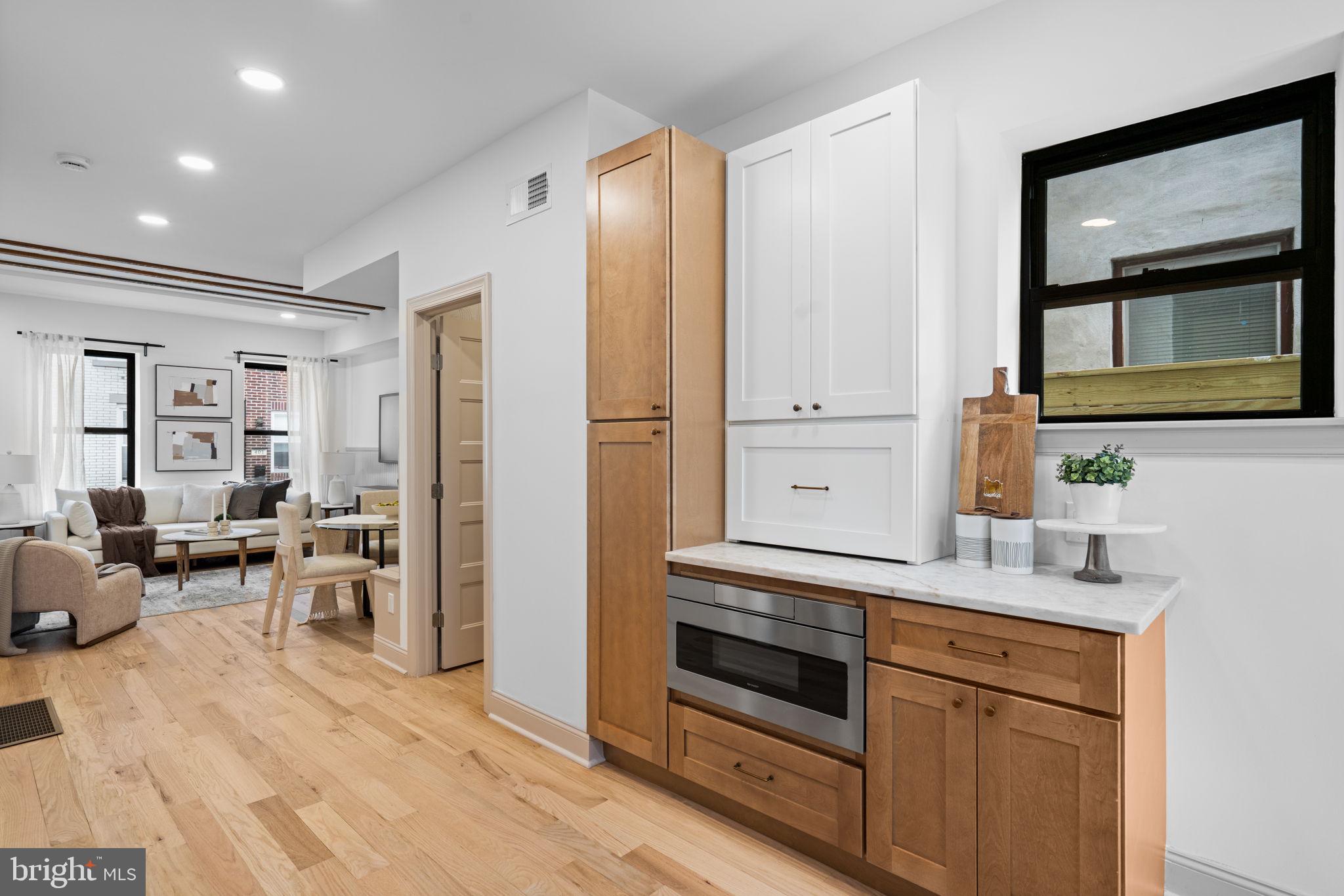 404 Pierce Street Philadelphia, PA 19148 - Photo 11 of 31 a kitchen with a refrigerator and white cabinets