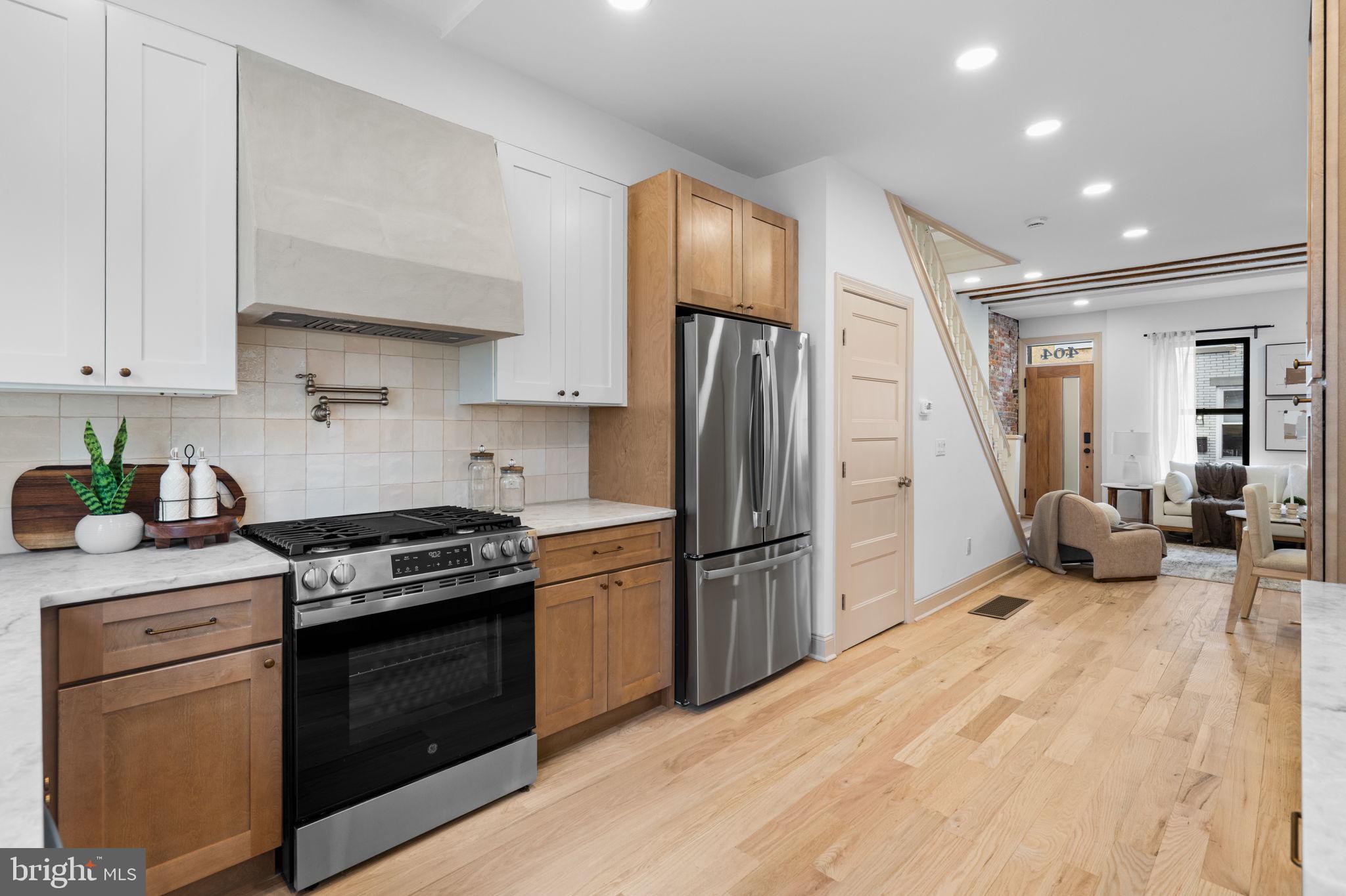 404 Pierce Street Philadelphia, PA 19148 - Photo 16 of 31 a kitchen with stainless steel appliances granite countertop a refrigerator stove and sink