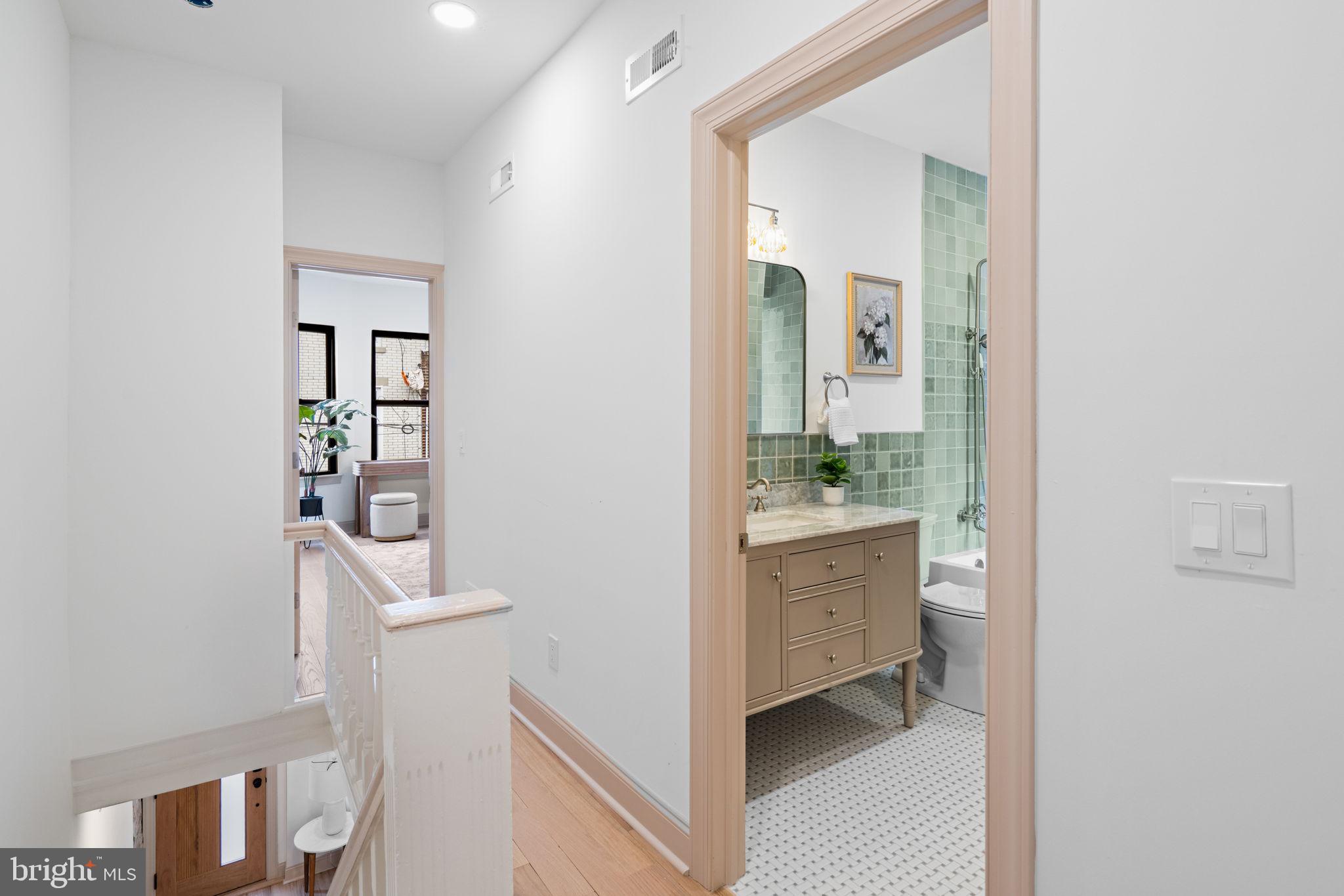 404 Pierce Street Philadelphia, PA 19148 - Photo 17 of 31 a bathroom with a sink a mirror and a shower