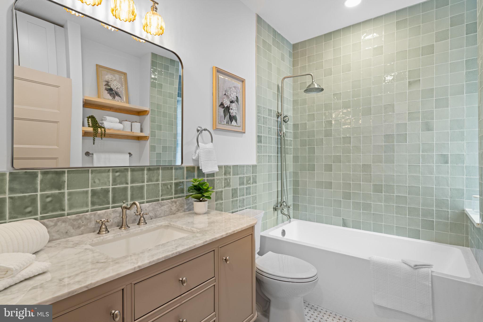 404 Pierce Street Philadelphia, PA 19148 - Photo 21 of 31 a bathroom with a granite countertop sink a toilet and bathtub