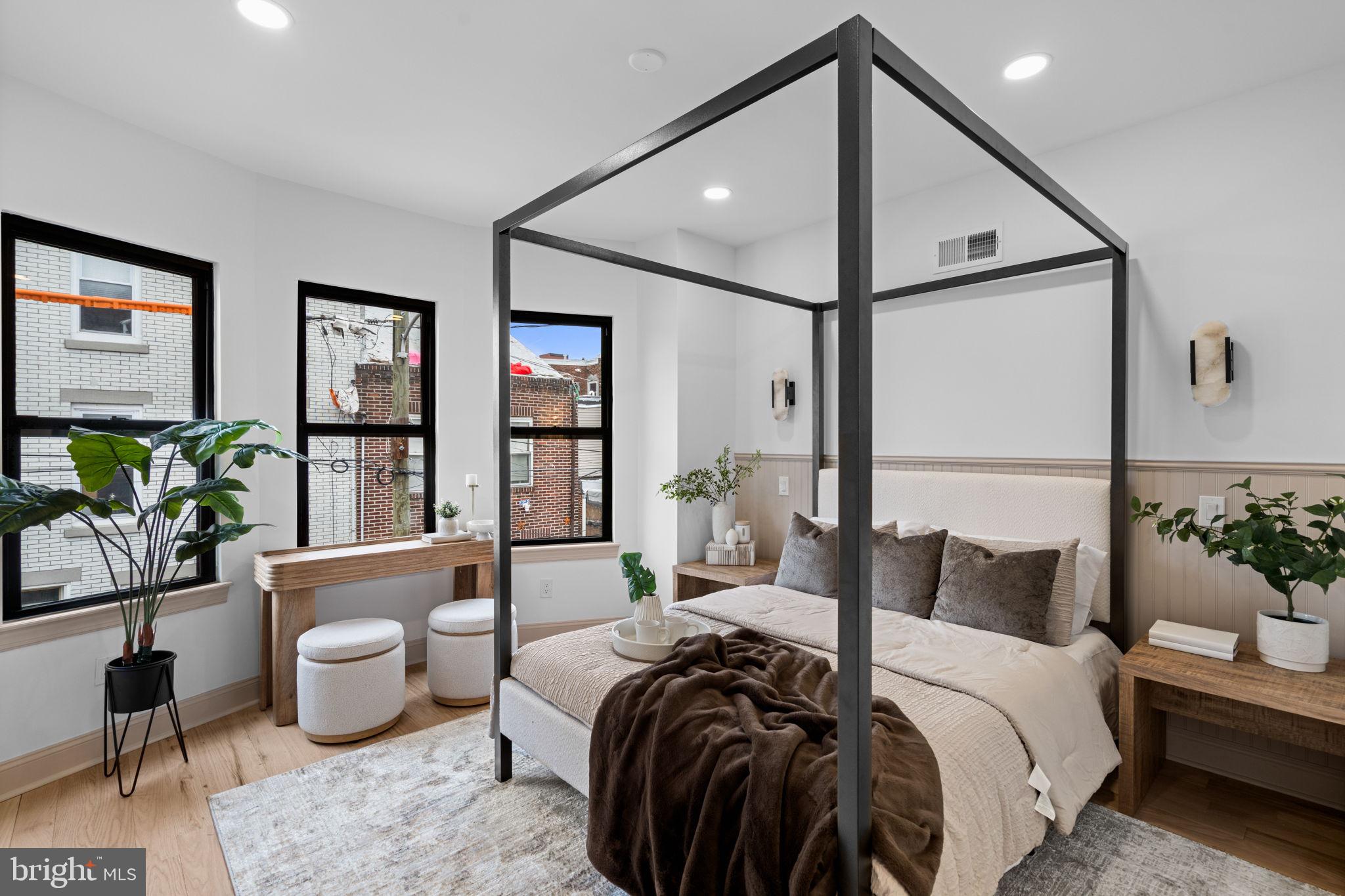 404 Pierce Street Philadelphia, PA 19148 - Photo 24 of 31 a bedroom with a bed a bookshelf and a potted plant
