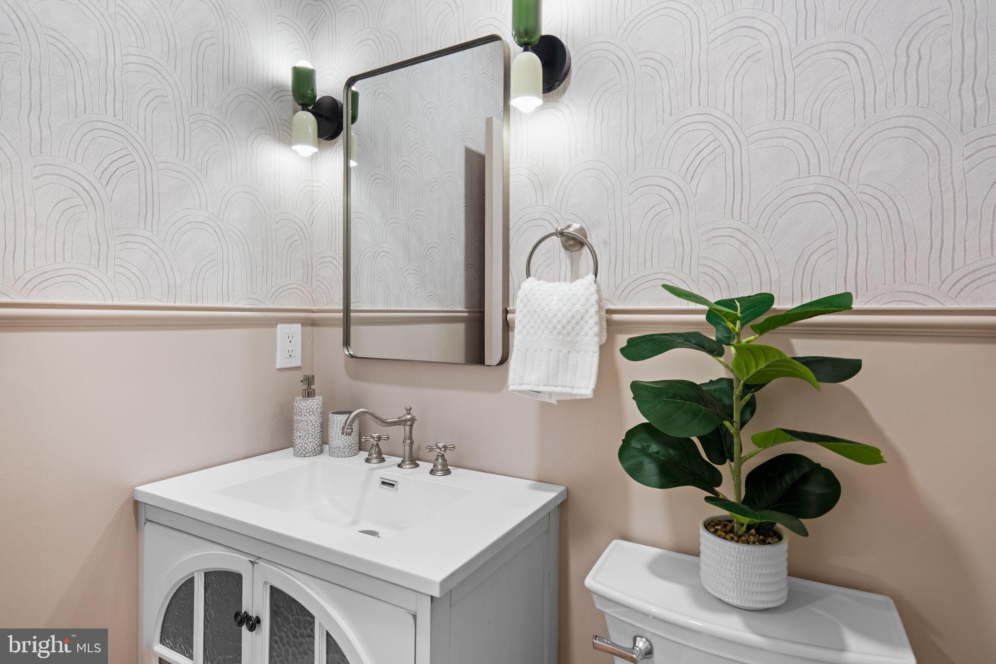 404 Pierce Street Philadelphia, PA 19148 - Photo 10 of 31 a bathroom with a sink a mirror and a potted plant