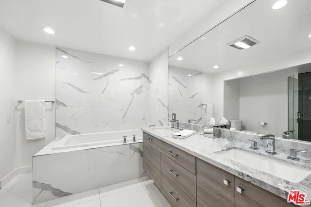 a bathroom with a double vanity sink mirror and double