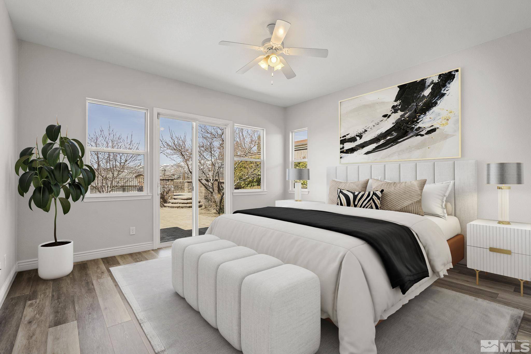 8115 Fire Opal Lane Reno, NV 89506 - Photo 17 of 40 a bedroom with a large bed and a chandelier