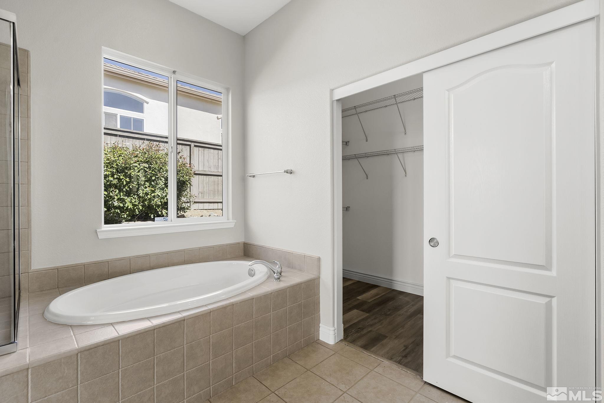 8115 Fire Opal Lane Reno, NV 89506 - Photo 20 of 40 a white bath tub sitting in a bathroom