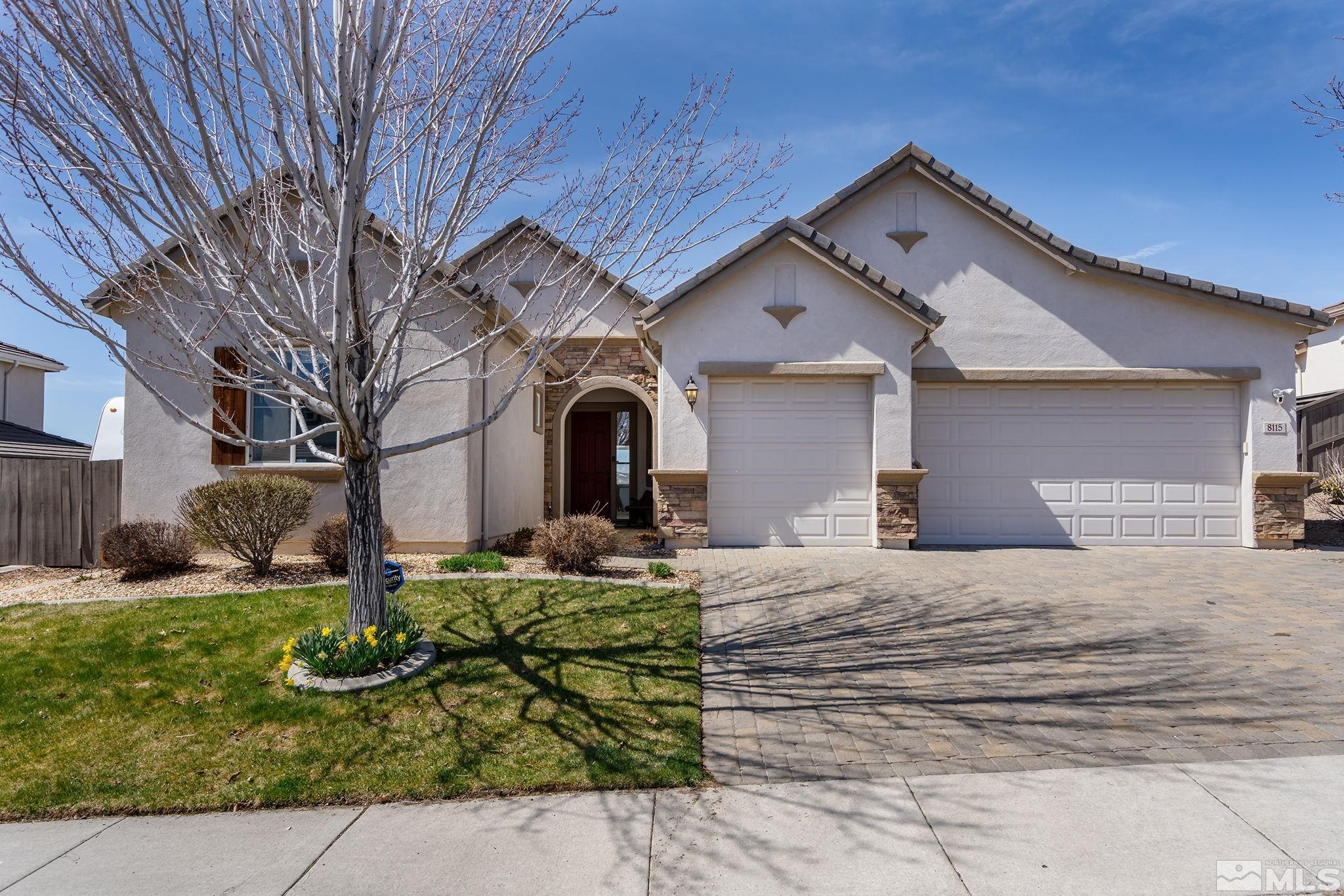 8115 Fire Opal Lane Reno, NV 89506 - Photo 2 of 40 a front view of a house with garden