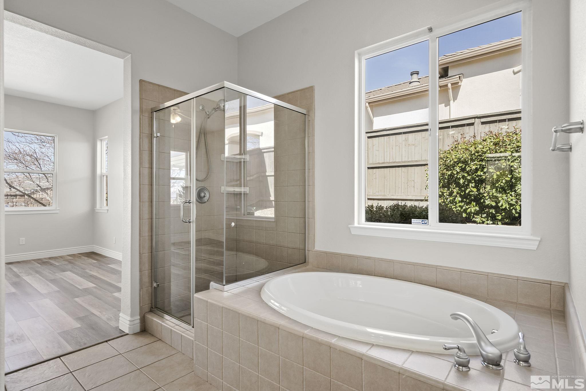 8115 Fire Opal Lane Reno, NV 89506 - Photo 21 of 40 a bathroom with a bathtub and shower