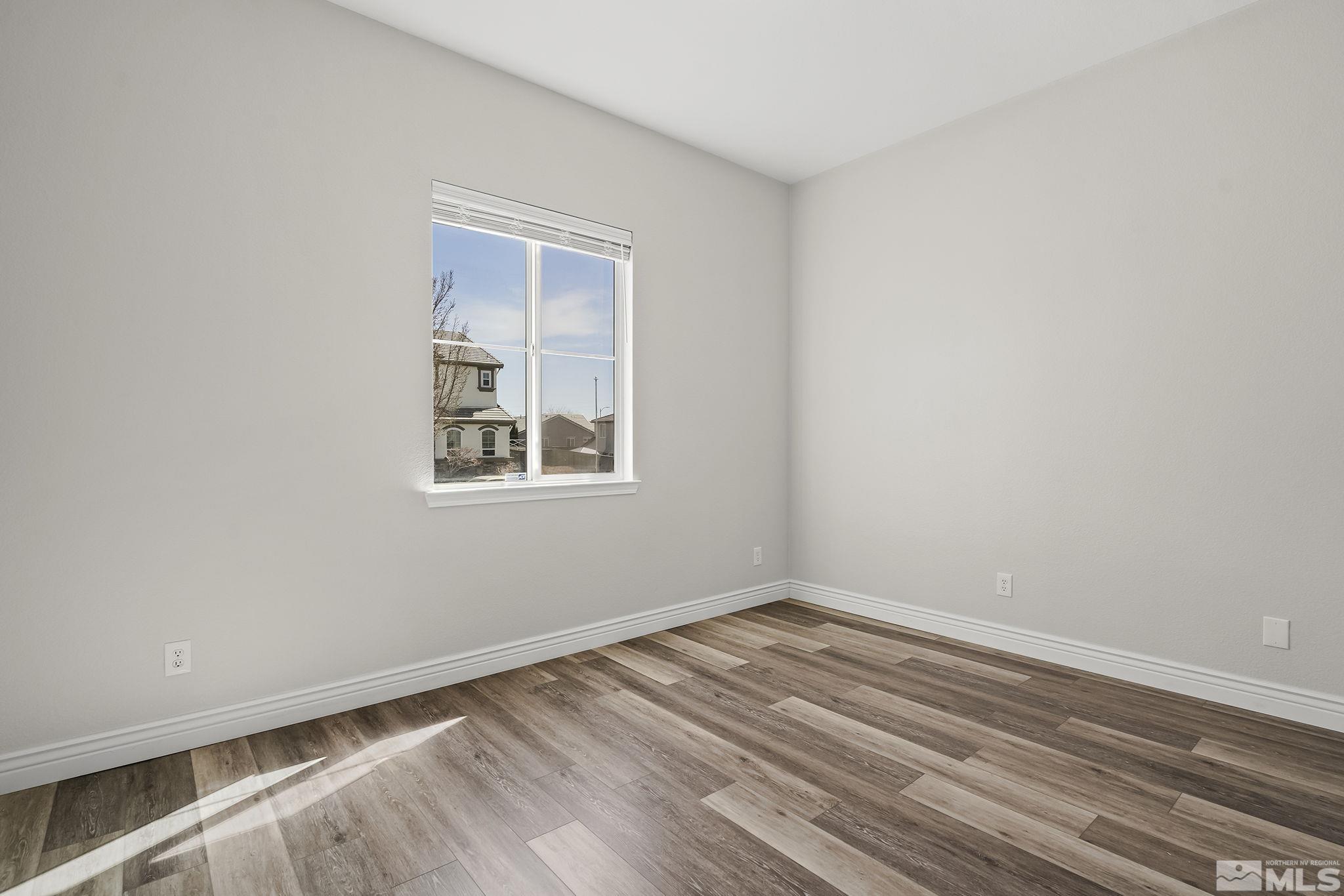 8115 Fire Opal Lane Reno, NV 89506 - Photo 22 of 40 a view of a room with wooden floor and windows