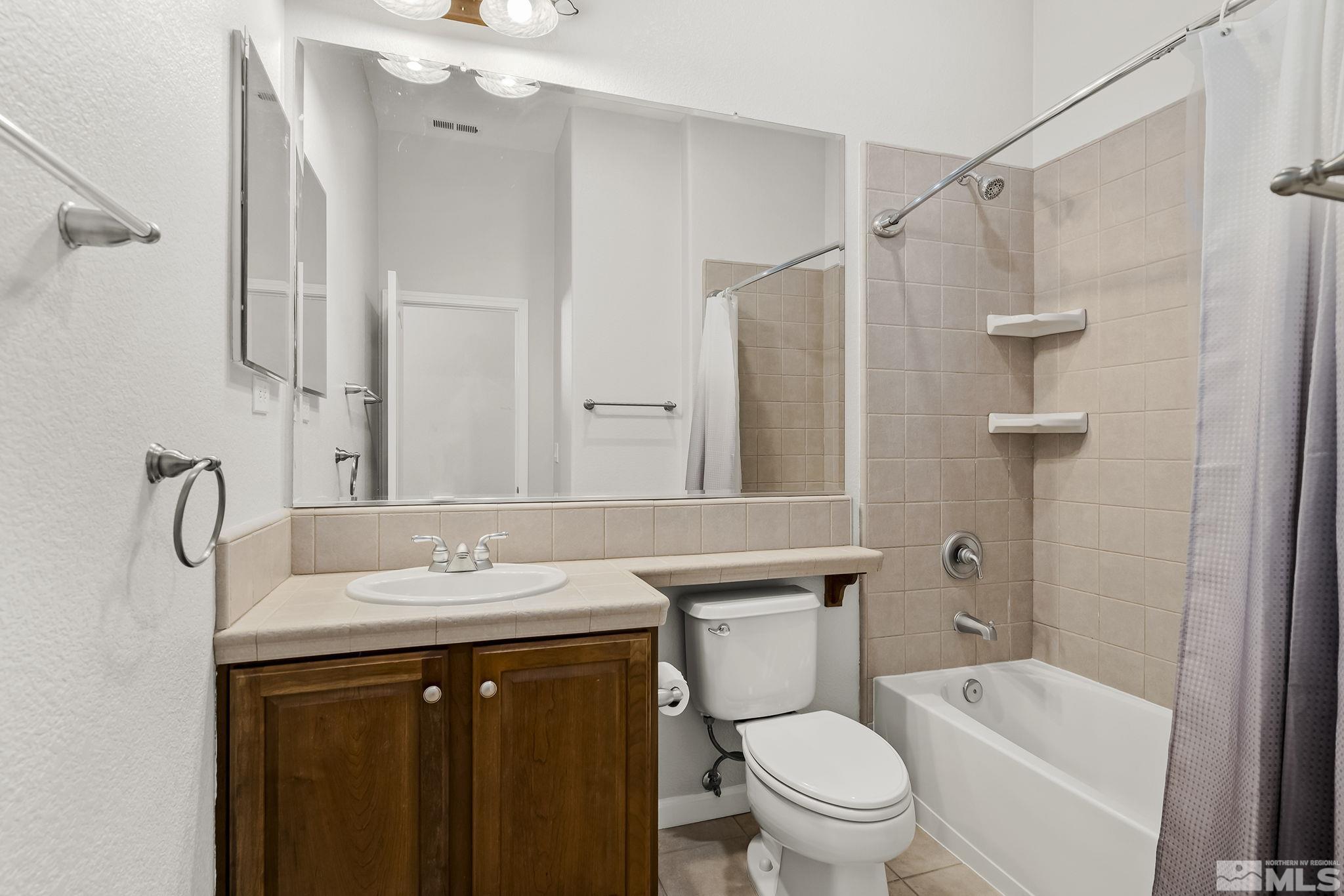 8115 Fire Opal Lane Reno, NV 89506 - Photo 24 of 40 a bathroom with a sink toilet and shower