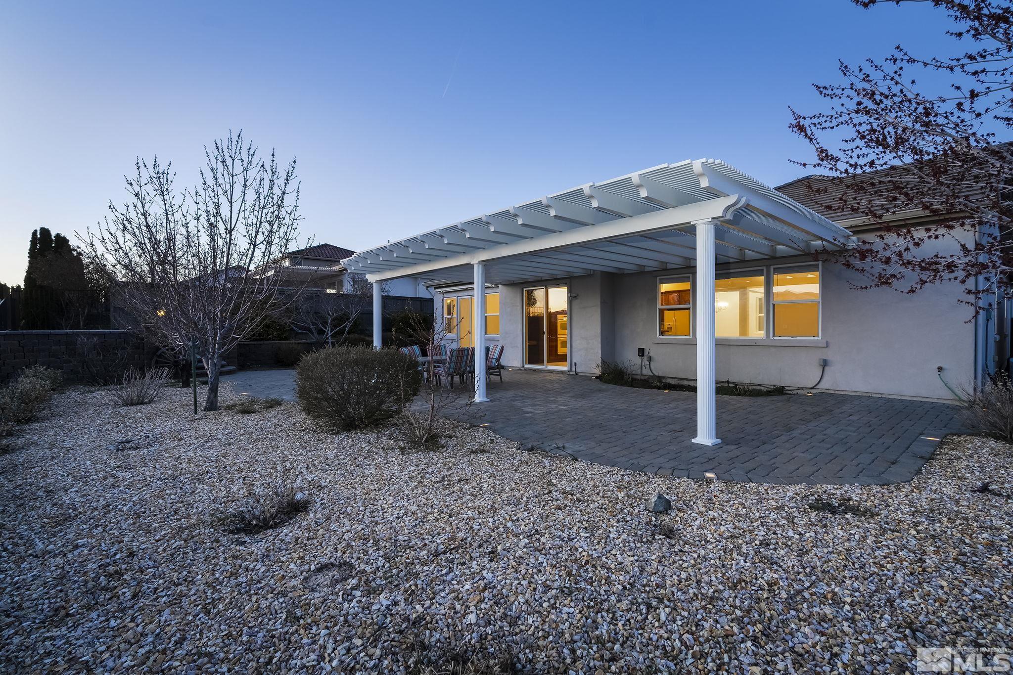 8115 Fire Opal Lane Reno, NV 89506 - Photo 30 of 40 a view of a house with backyard and trees
