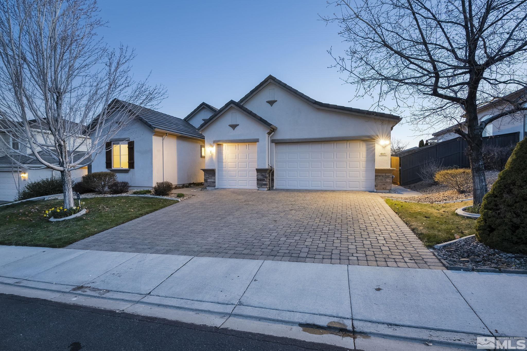 8115 Fire Opal Lane Reno, NV 89506 - Photo 3 of 40 a front view of house with yard and trees around