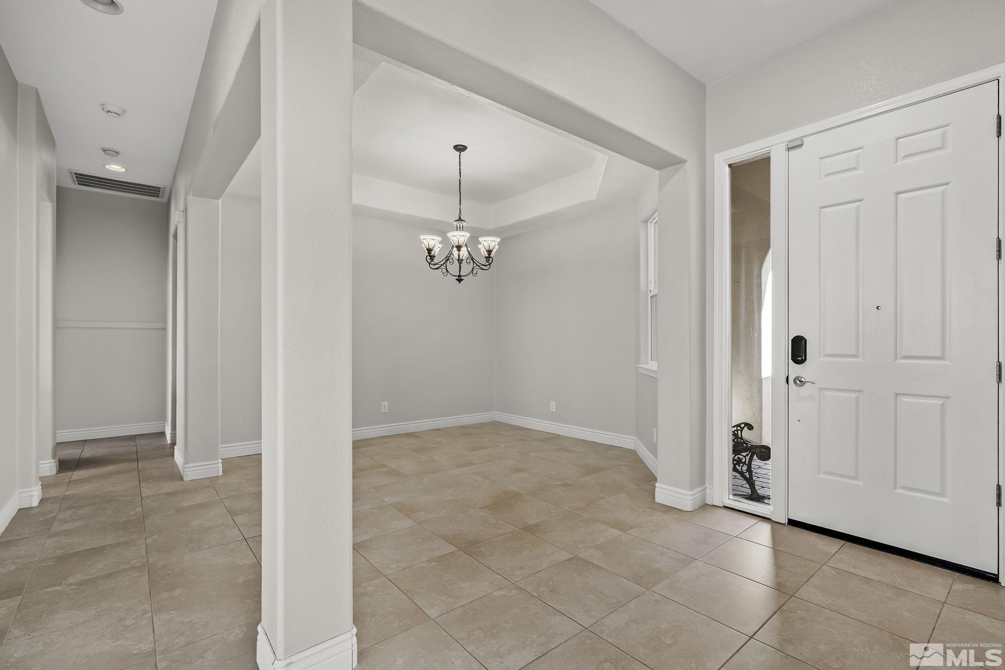 8115 Fire Opal Lane Reno, NV 89506 - Photo 5 of 40 a view of a chandelier fan in a room