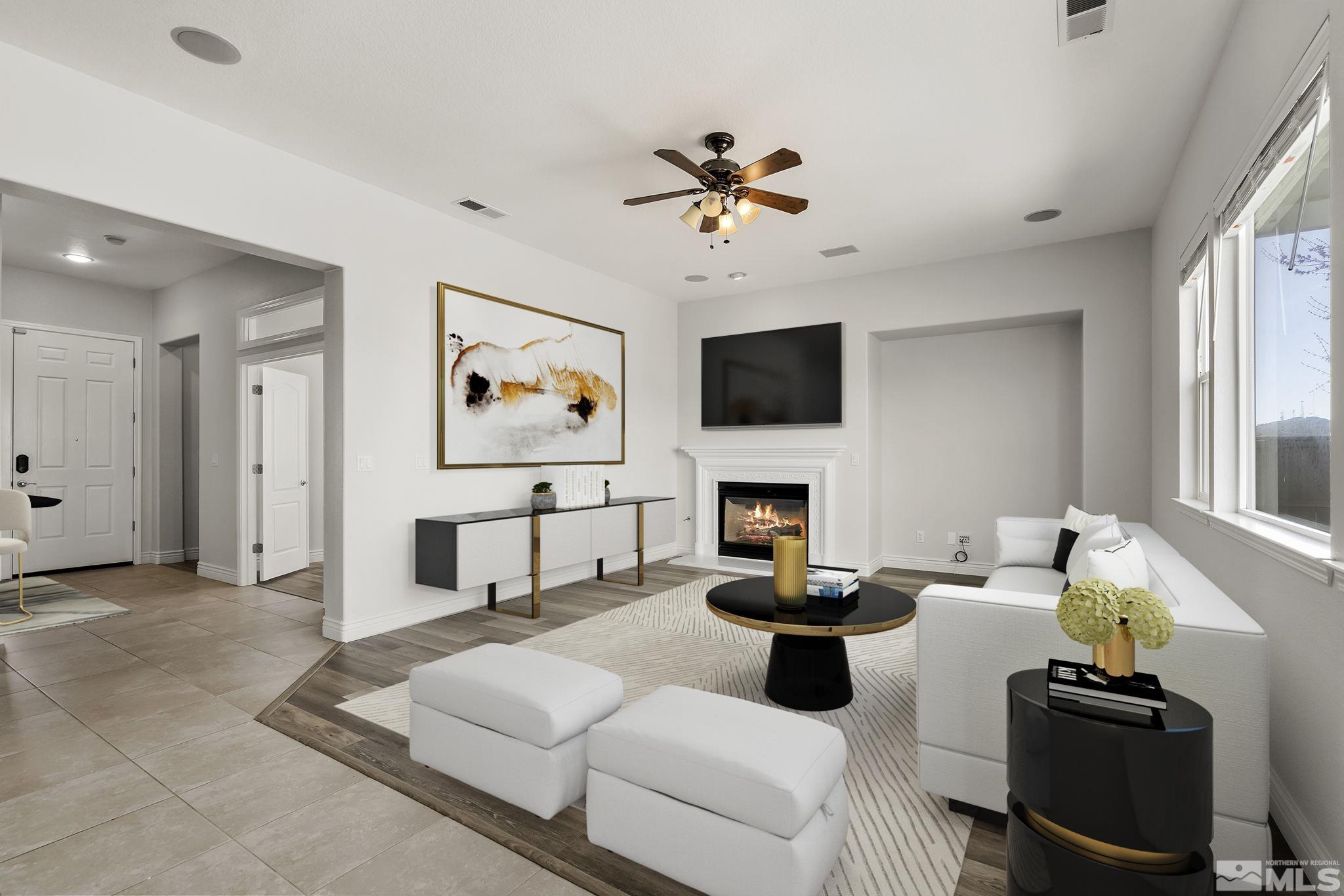 8115 Fire Opal Lane Reno, NV 89506 - Photo 10 of 40 a living room with furniture a fireplace and a flat screen tv