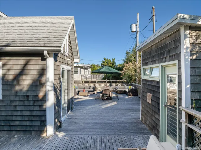 a view of terrace with barbeque oven and outdoor seating