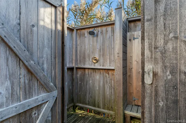 a bedroom with a flat screen tv on dresser and a flat screen tv