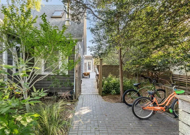 a view of a backyard with plants and a patio