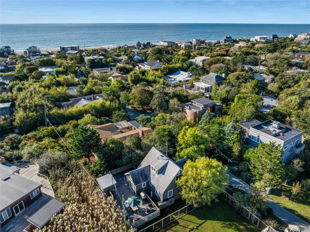 an aerial view of a houses with a yard
