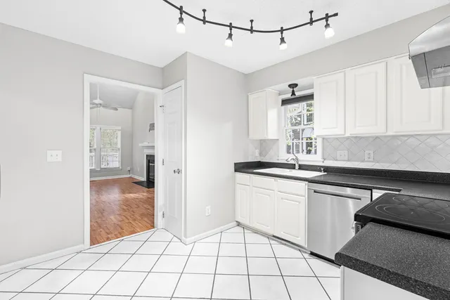 a kitchen with a sink cabinets and window