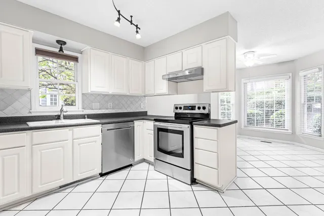 a kitchen with a sink cabinets and window