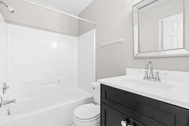 a bathroom with a sink a toilet and bathtub