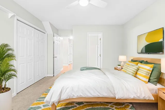 a bedroom with a bed and a potted plant