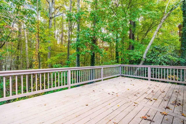 a view of balcony with wooden floor and fence