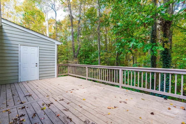 a view of balcony with wooden floor and fence