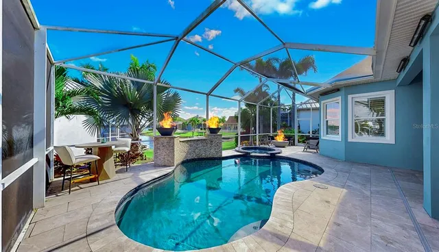 an outdoor patio with swimming pool table and chairs