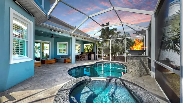 a living room with patio furniture and a floor to ceiling window