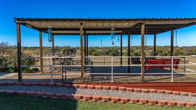 a view of a backyard with wooden fence