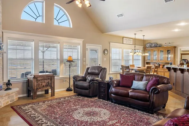 a living room with furniture potted plant and a large window
