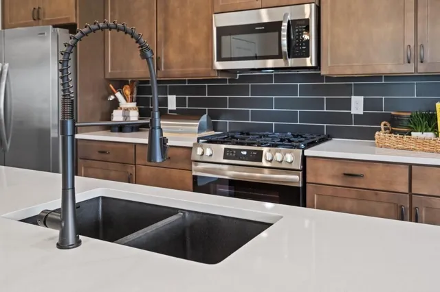 a large kitchen with a table and chairs