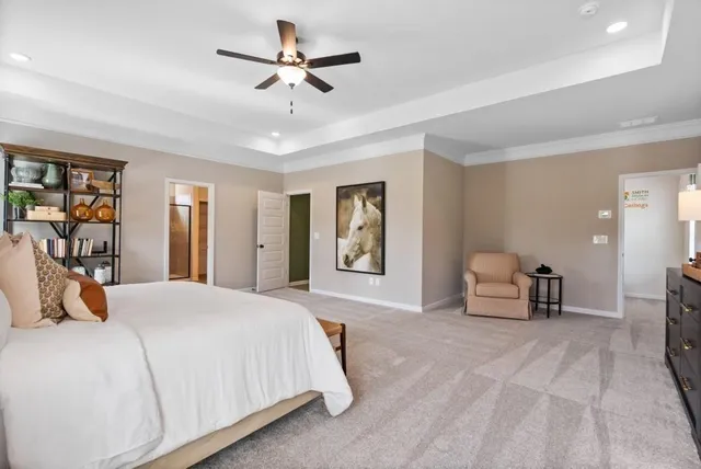 a spacious bedroom with a bed and cabinet