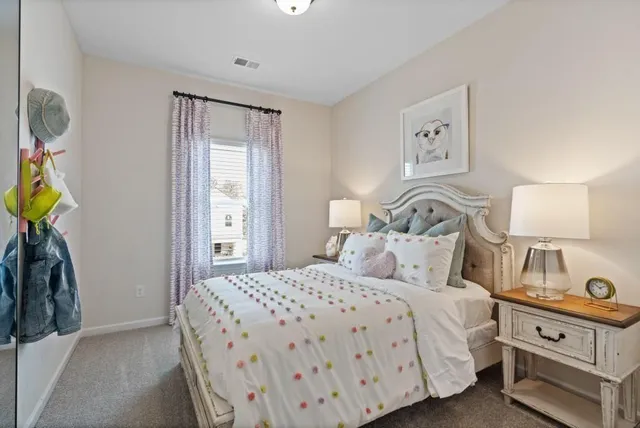 a bedroom with a bed and painting on the wall