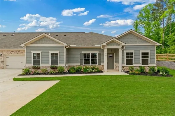 a front view of a house with a yard