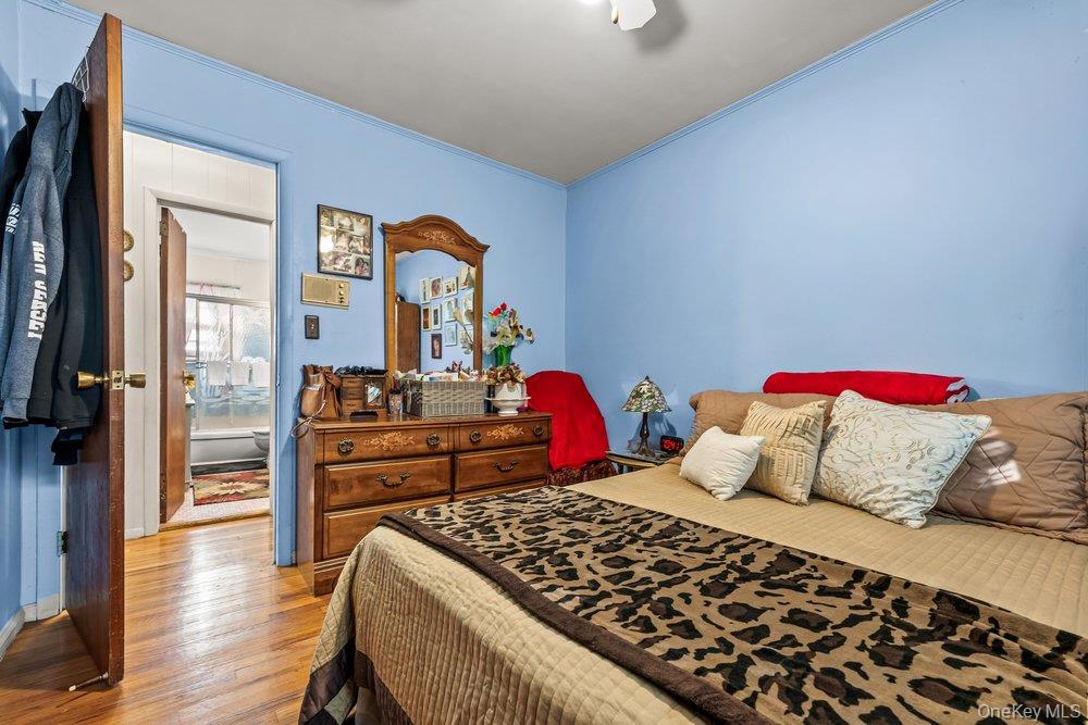 145-95 221st Street Queens, NY 11413 - Photo 14 of 38 a bedroom with a bed and a table