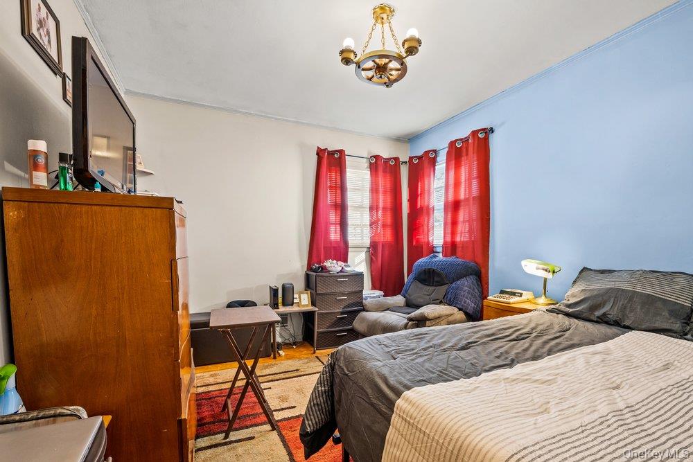 145-95 221st Street Queens, NY 11413 - Photo 15 of 38 a bedroom with a bed and a table