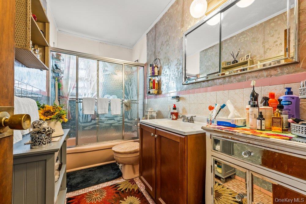 145-95 221st Street Queens, NY 11413 - Photo 20 of 38 a kitchen with stainless steel appliances a sink and cabinets