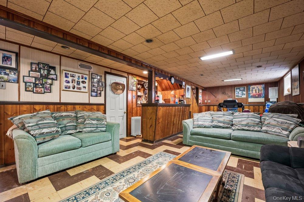 145-95 221st Street Queens, NY 11413 - Photo 27 of 38 a living room with furniture and a rug