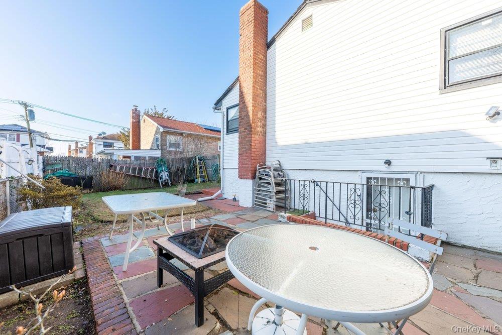 145-95 221st Street Queens, NY 11413 - Photo 37 of 38 a view of a balcony with a table and chairs