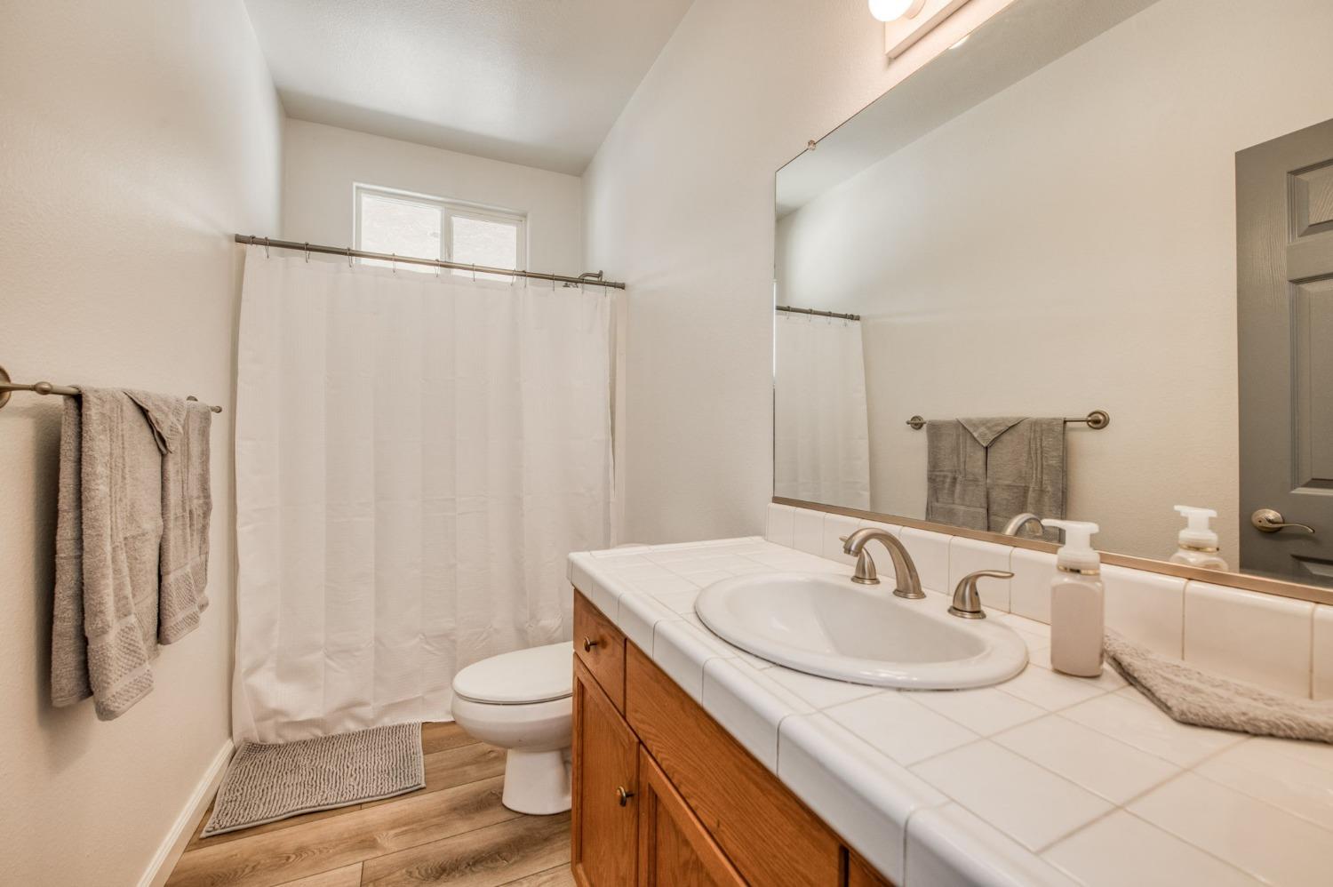 6980 Chaparral Drive Sanger, CA 93657 - Photo 41 of 41 a bathroom with a sink toilet and shower