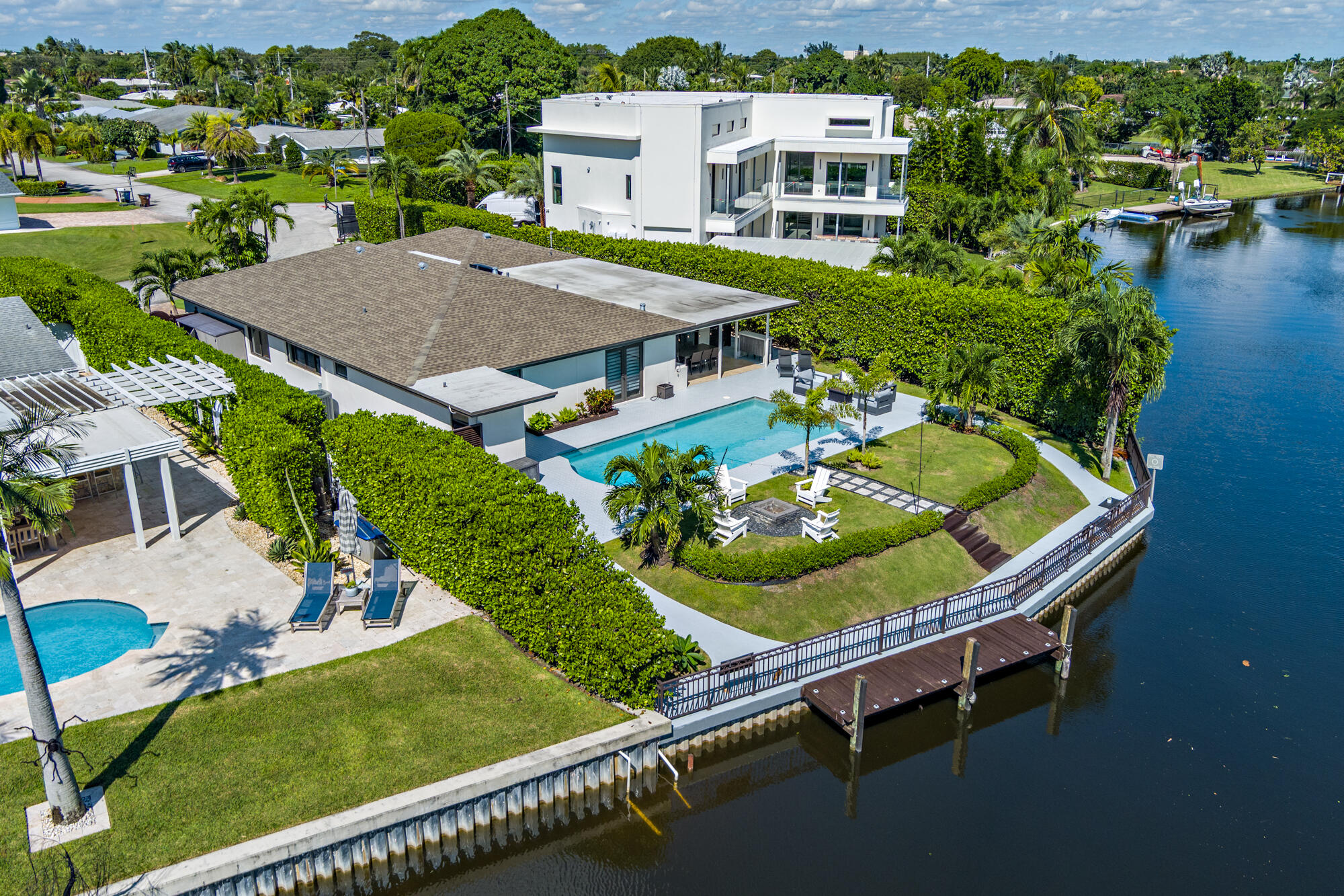 an aerial view of a house with a garden and lake view