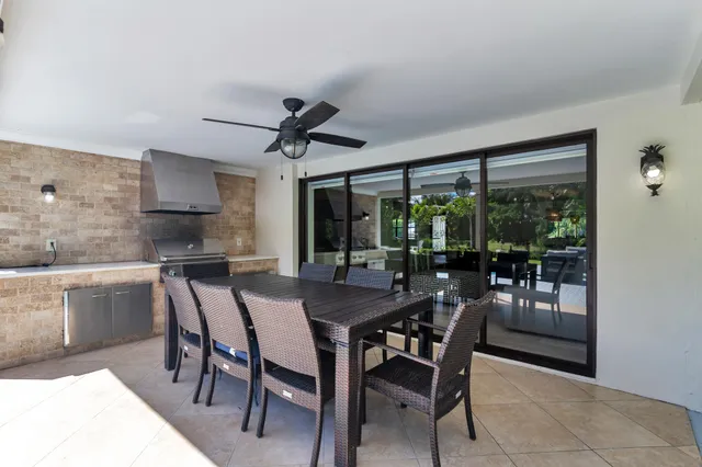 a dining room with furniture a chandelier and window