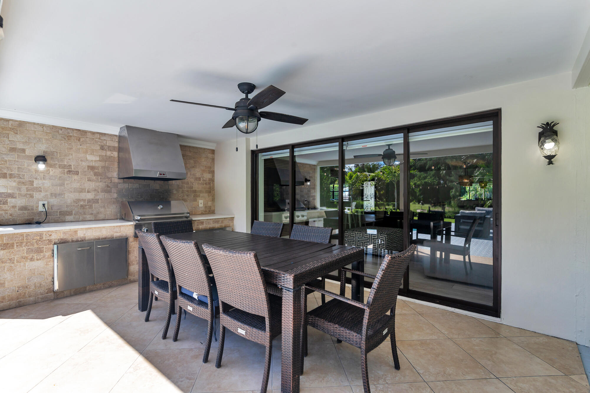 7730 Beta Circle Lake Clarke Shores, FL 33406 - Photo 11 of 50 a dining room with furniture a chandelier and window