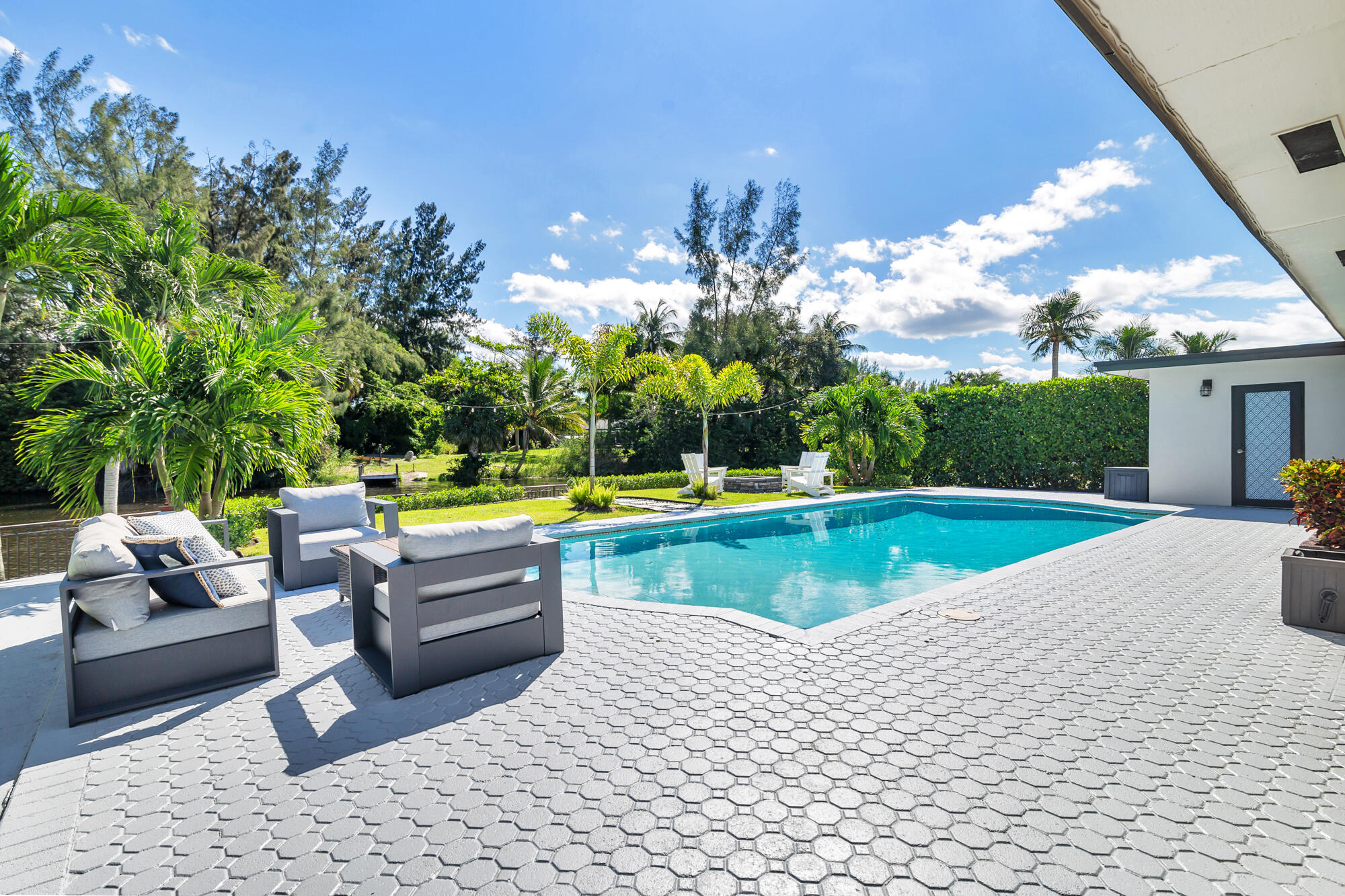7730 Beta Circle Lake Clarke Shores, FL 33406 - Photo 12 of 50 a view of swimming pool with seating space and couches in the patio